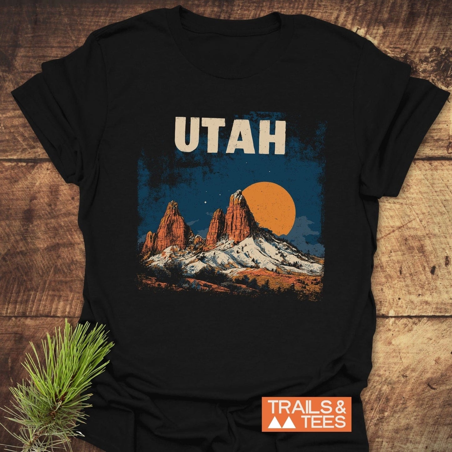 Utah Retro T-Shirt featuring UTAH text and vintage red rock landscape, crafted from soft cotton for comfort and durability, with Trails & Tees logo visible.
