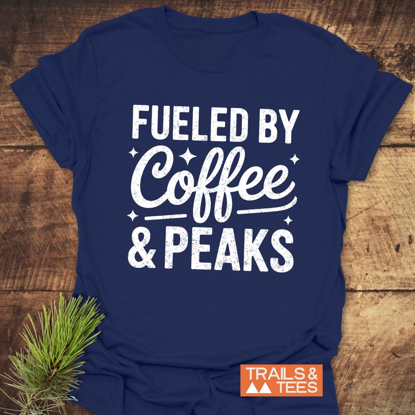 Fueled By Coffee And Peaks T-Shirt with a distressed slogan, small orange logo, crafted from soft cotton, ideal for outdoor enthusiasts.