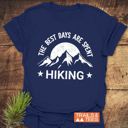 The Best Days Are Spent Hiking T-Shirt, featuring mountain peaks and sun graphic, crafted from soft cotton with durable prints, ideal for outdoor enthusiasts.