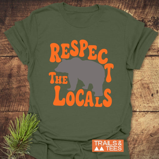 Respect The Locals Bear T-Shirt features a gray bear silhouette with retro orange text on soft, lightweight cotton, emphasizing outdoor adventure and sustainability.