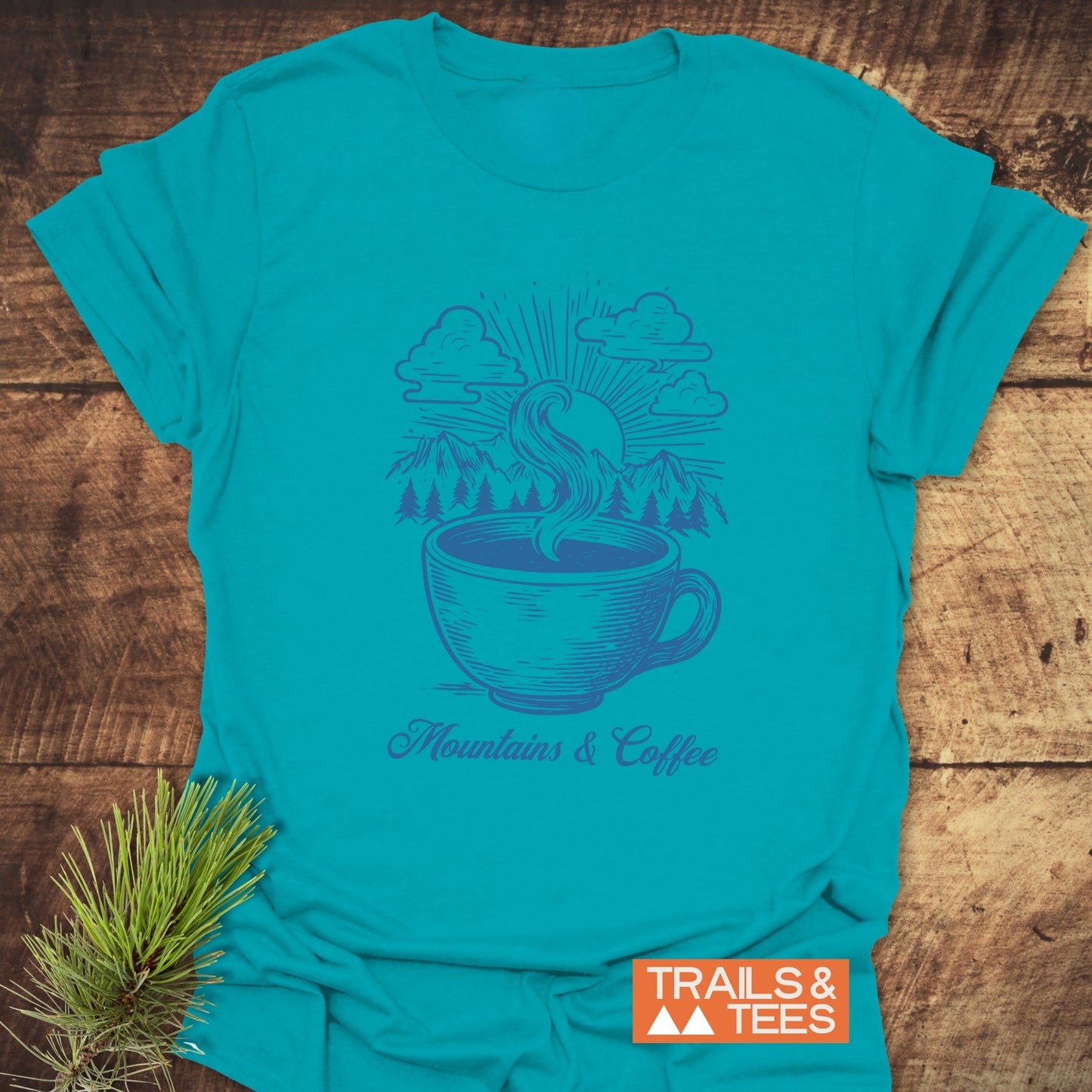 Mountains And Coffee T-Shirt featuring a coffee cup-mountain scene. Soft, ring-spun cotton for comfort. Durable print. Pre-shrunk and seamless for lasting wear.