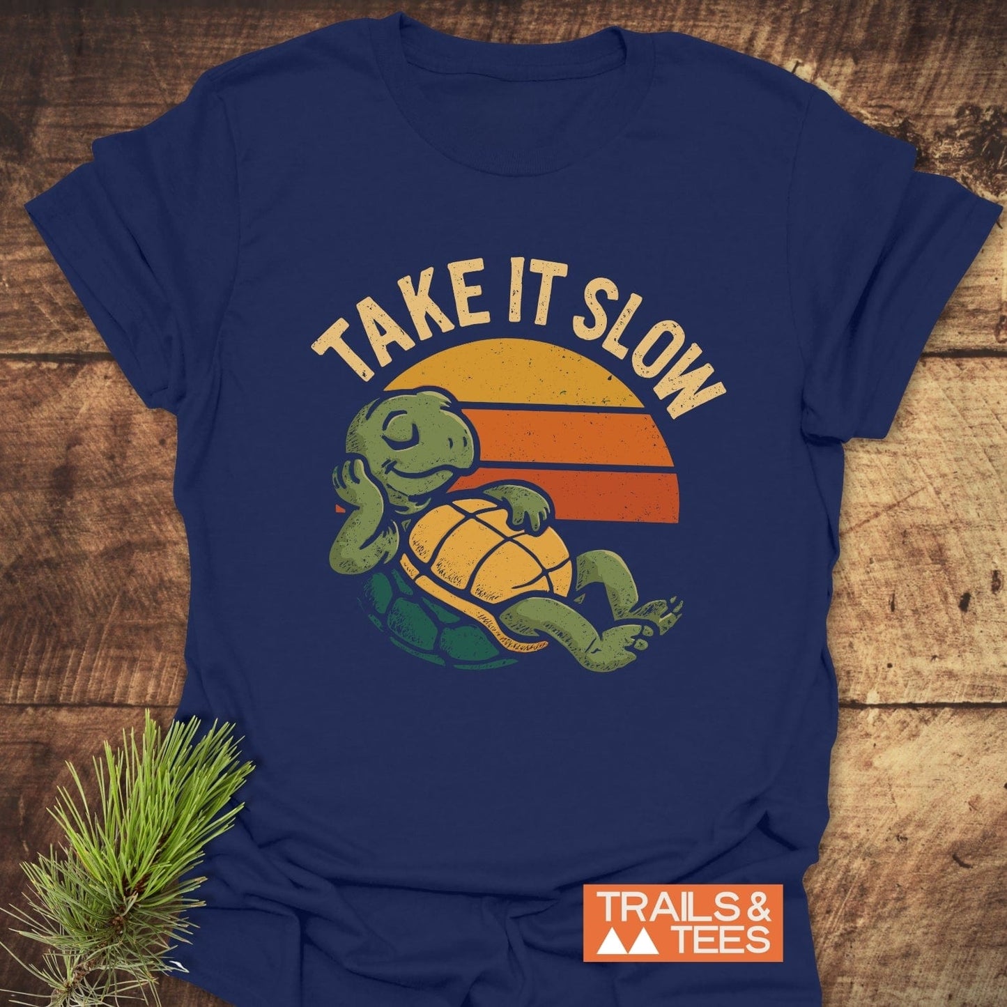 Take It Slow Turtle T-Shirt featuring a retro turtle graphic and TAKE IT SLOW slogan, designed for comfort with durable print and pre-shrunk fit.