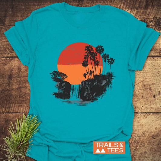Sunset Waterfalls T-Shirt featuring a sunset graphic with palm silhouettes, crafted from soft ring-spun cotton, ensuring trail-tested comfort and durability.