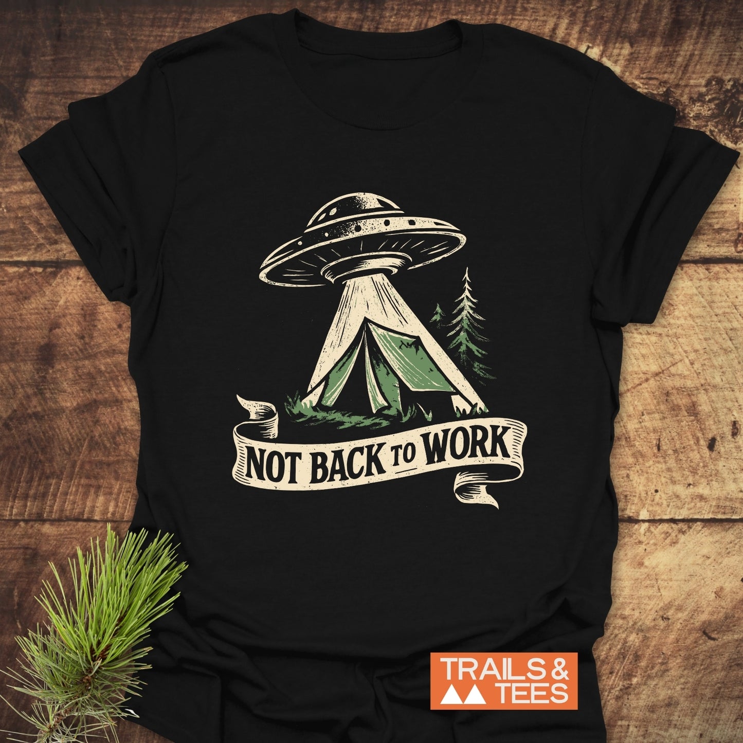 Not Back To Work T-Shirt featuring a flying saucer graphic above a camping scene. Crafted from soft cotton, ideal for outdoor enthusiasts.