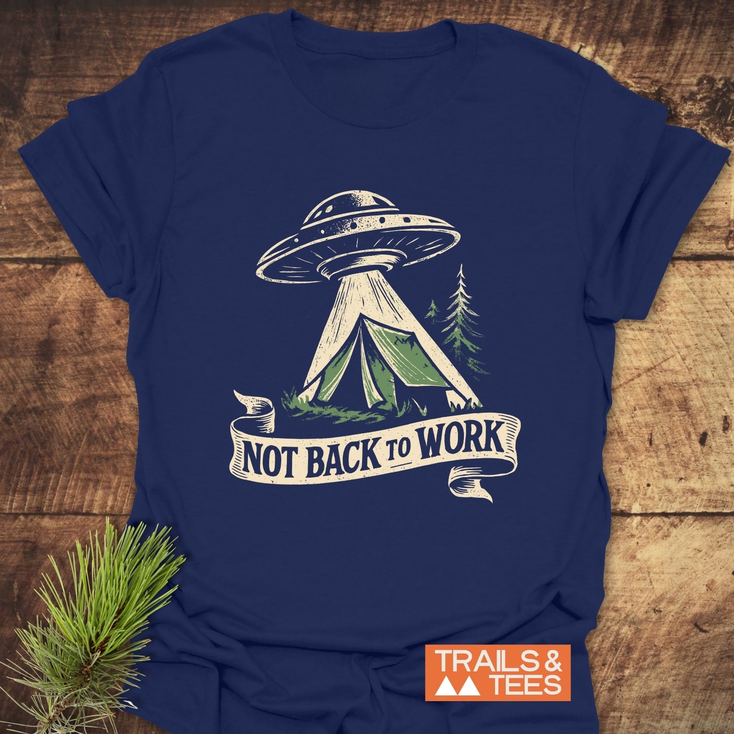 Not Back To Work T-Shirt featuring a UFO and camping tent design, conveying outdoor adventure. Made from soft cotton, with durable prints and a small Trails & Tees logo.