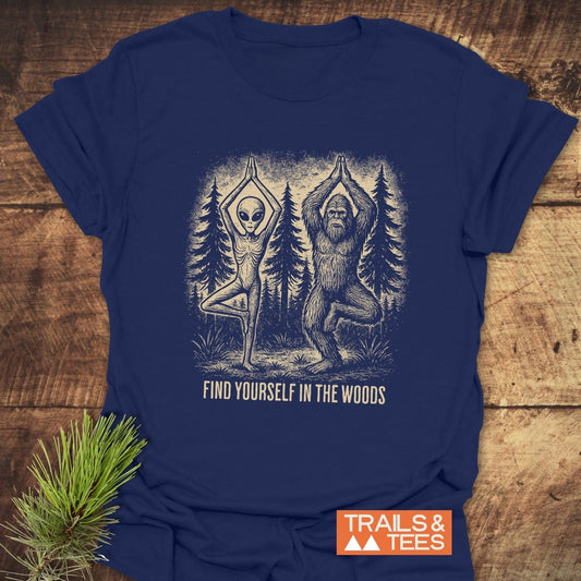 Find Yourself In The Woods T-Shirt featuring an alien and Bigfoot in tree pose, slogan below, on a soft, durable, ring-spun cotton tee.