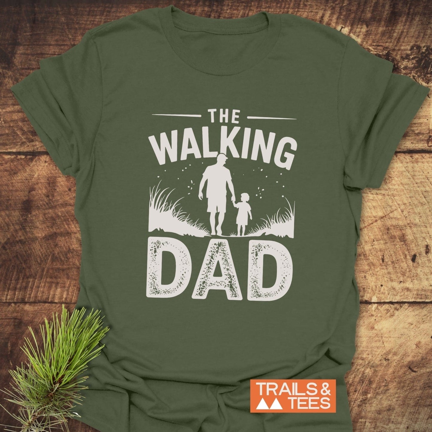 The Walking Dad T-Shirt showcases a father-child silhouette and slogan, highlighting its outdoor theme. Made from soft, durable cotton, perfect for everyday adventures.