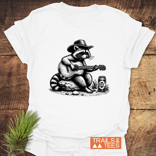 Guitar Playing Raccoon T-Shirt featuring a raccoon in a cowboy hat with a guitar, crafted from soft cotton for outdoor adventures.