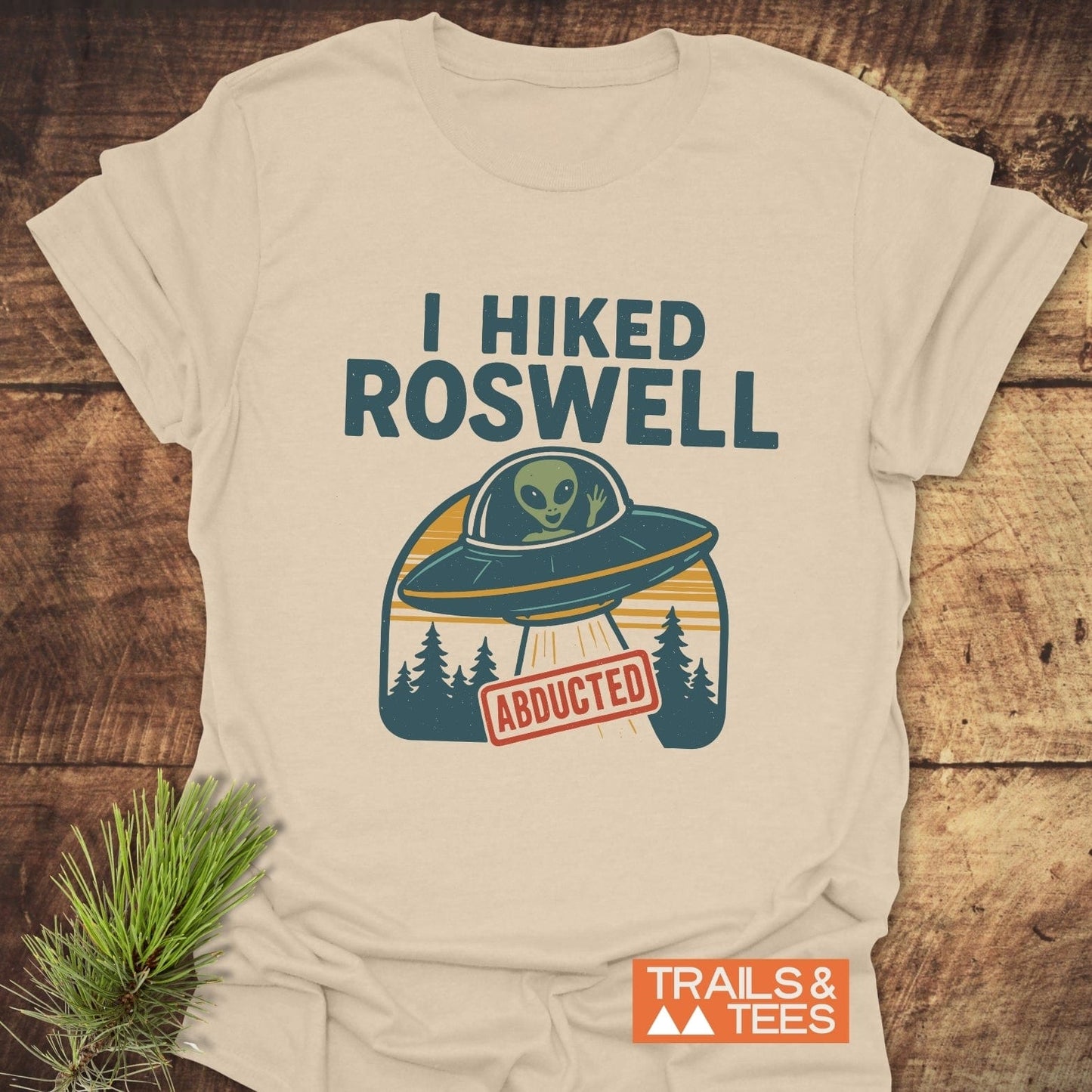 I Hiked Roswell T-Shirt featuring a UFO and forest graphic with an alien, made of soft ring-spun cotton, offering comfort and durability.