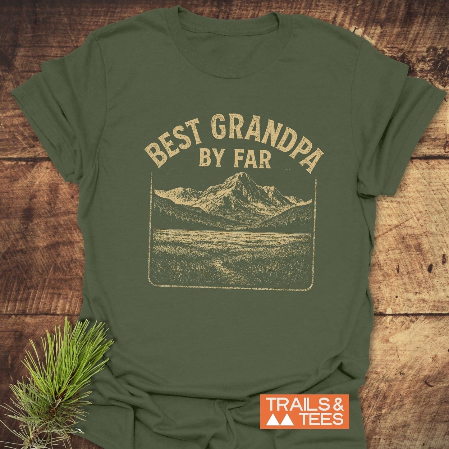 Best Grandpa By Far T-Shirt with vintage mountain scene, crafted from soft ring-spun cotton. Includes durable prints and features a Trails & Tees logo.