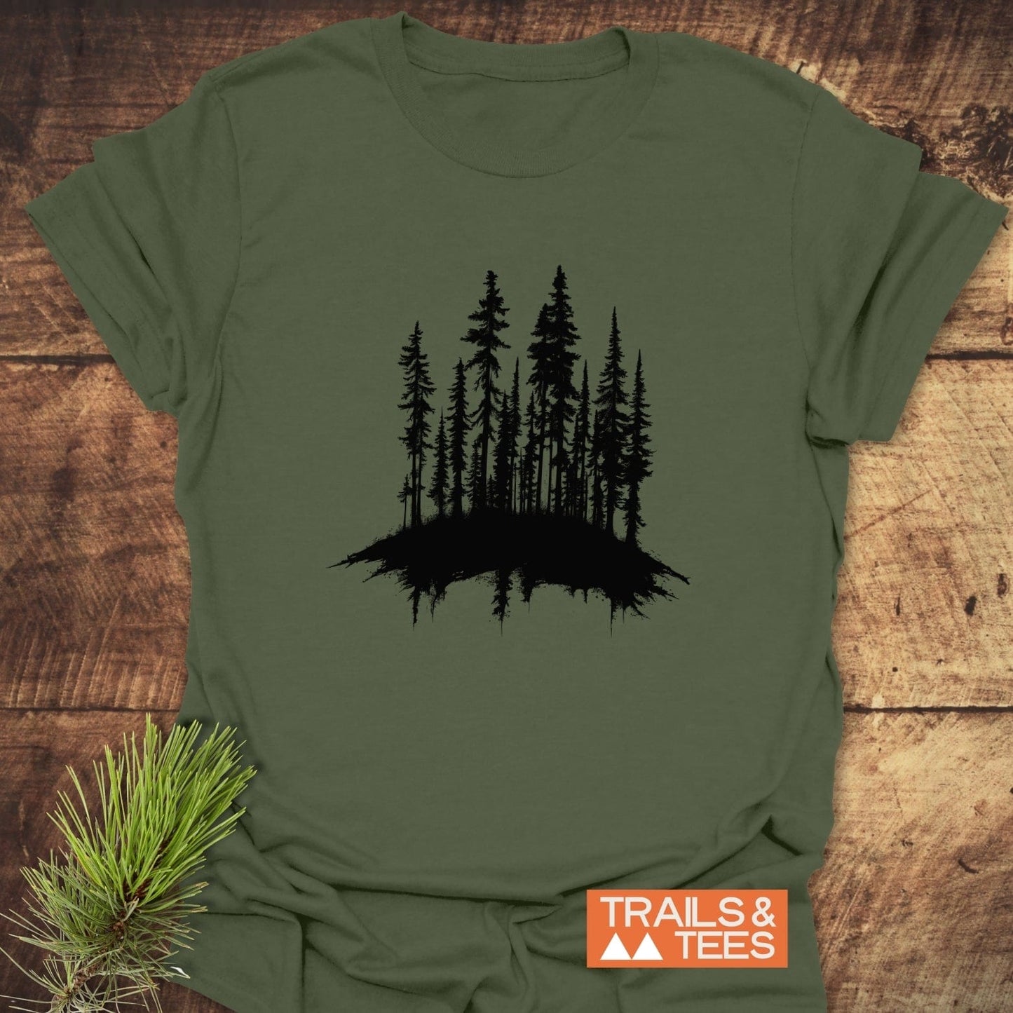 Woods Silhouette T-Shirt featuring a pine tree graphic and mirrored reflection, crafted from soft ring-spun cotton for comfort and durability, ideal for outdoor enthusiasts.