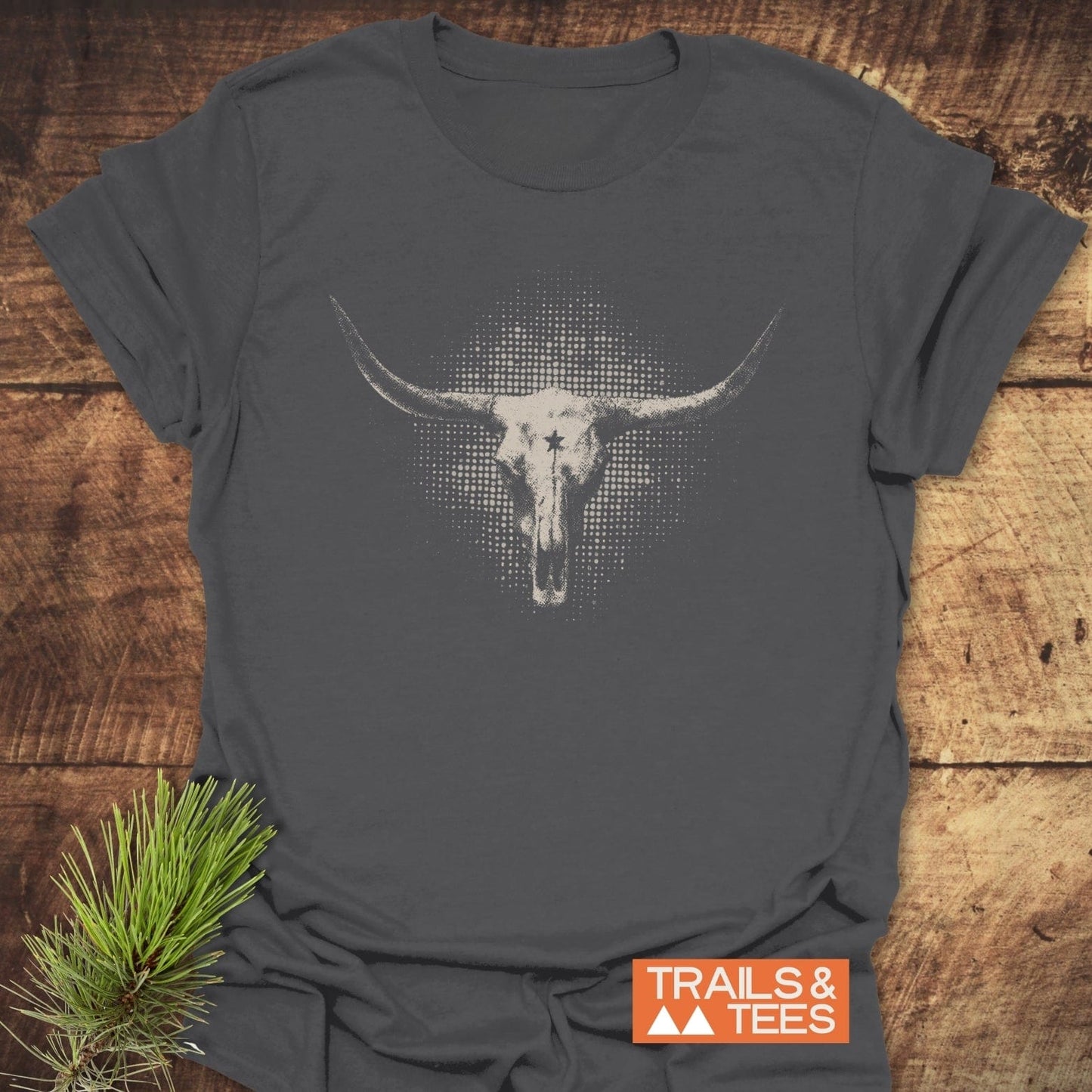 Buffalo Skull Texas T-Shirt features a longhorn skull graphic, emphasizing outdoor adventure with soft, durable cotton and a rustic pine branch accent.