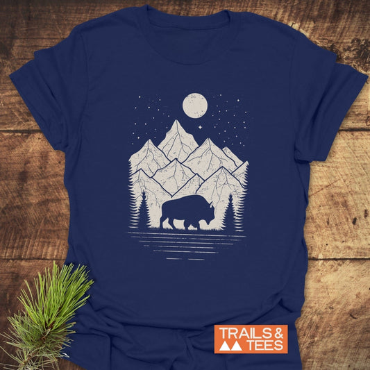 Nightsky Buffalo T-Shirt featuring a bison, pine trees, mountains, and starry sky design, showcasing outdoor spirit. Soft cotton, durable print, and pre-shrunk for comfort.