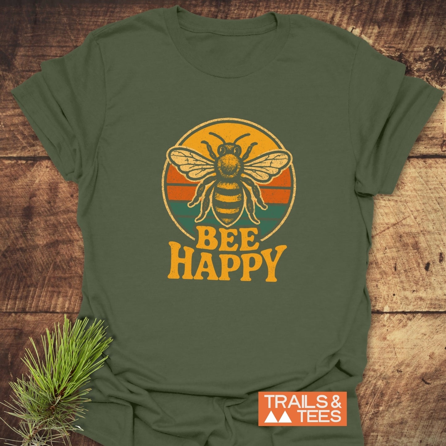 Olive-green Bee Happy T-Shirt with retro bumblebee and sunset graphic, made from soft cotton, featuring durable print and outdoorsy theme.