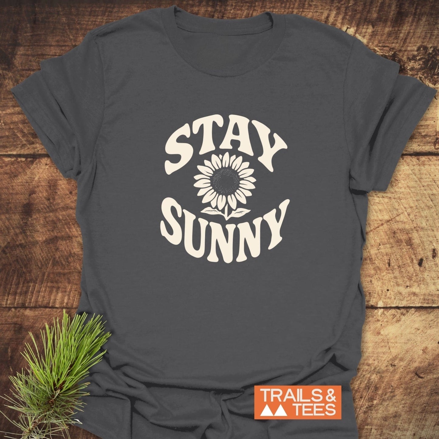 Stay Sunny T-Shirt featuring a cream sunflower design on dark-charcoal fabric, with durable prints and a comfortable fit, perfect for outdoor enthusiasts.