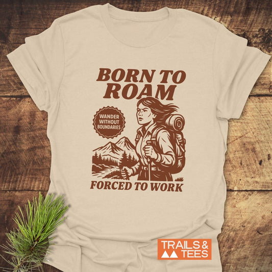 Born To Roam T-Shirt featuring a hiker design with trekking gear, set against a mountain scene, promoting outdoor adventure and everyday comfort.