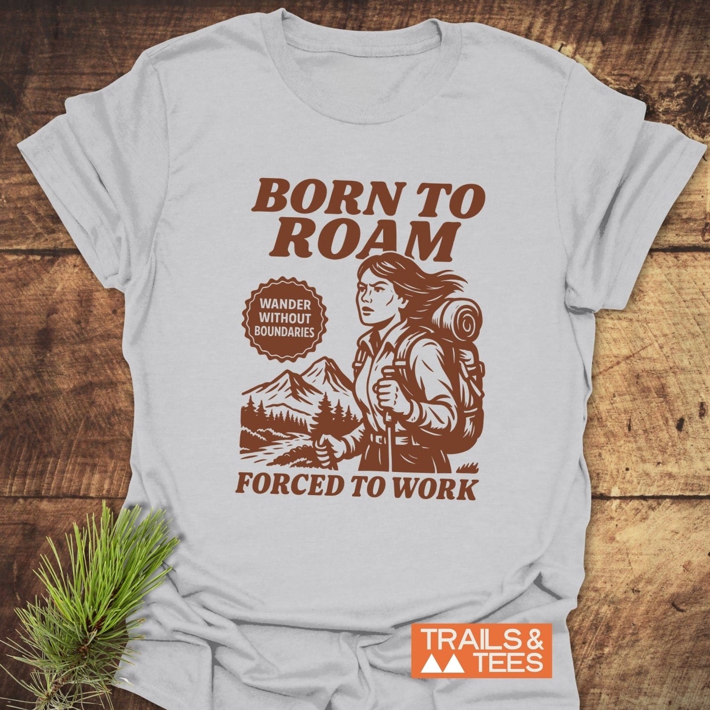 Born To Roam T-Shirt featuring a hiker illustration with trekking poles, highlighting mountain scenery, and inspirational text; crafted from soft, durable cotton for outdoor enthusiasts.