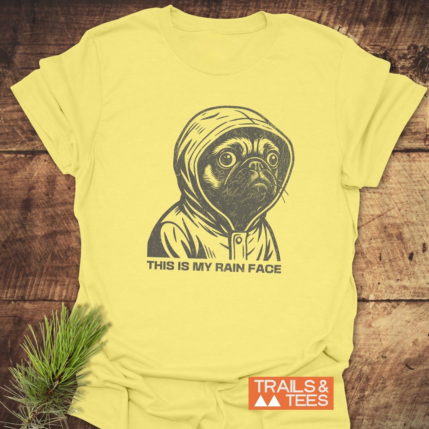 This Is My Rain Face T-Shirt featuring a sketched pug in a raincoat, crafted from soft ring-spun cotton with a durable print, by Trails & Tees.