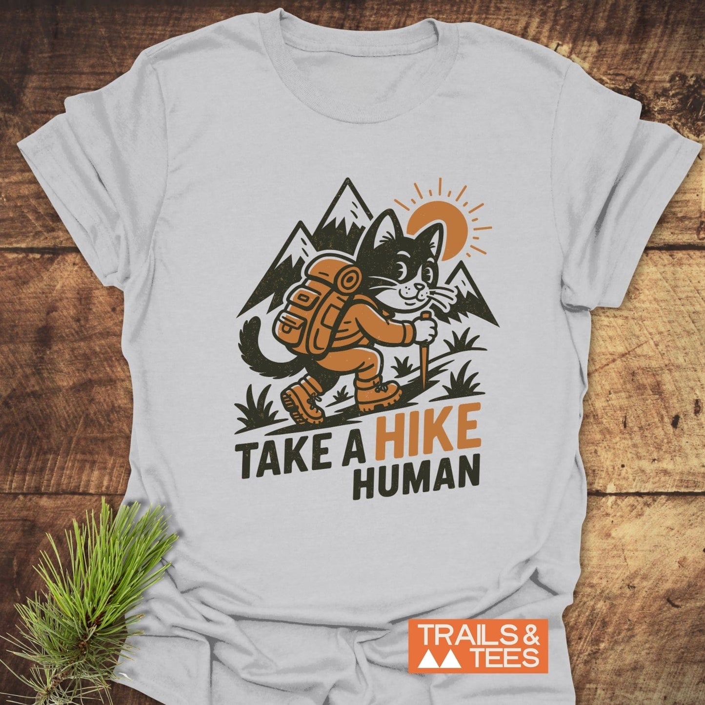 Take A Hike Human T-Shirt featuring a cartoon hiking cat and slogan, crafted from soft cotton for comfort, with durable prints and eco-friendly production.