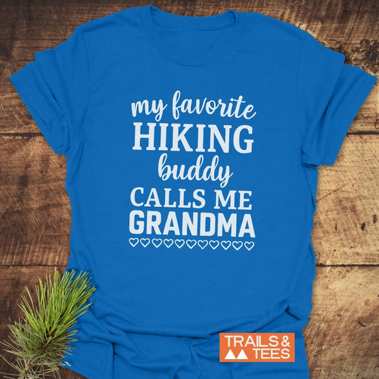 Hiking Grandma T-Shirt in bright blue with my favorite HIKING buddy CALLS ME GRANDMA in white text, featuring heart outlines. TRAILS & TEES logo visible.