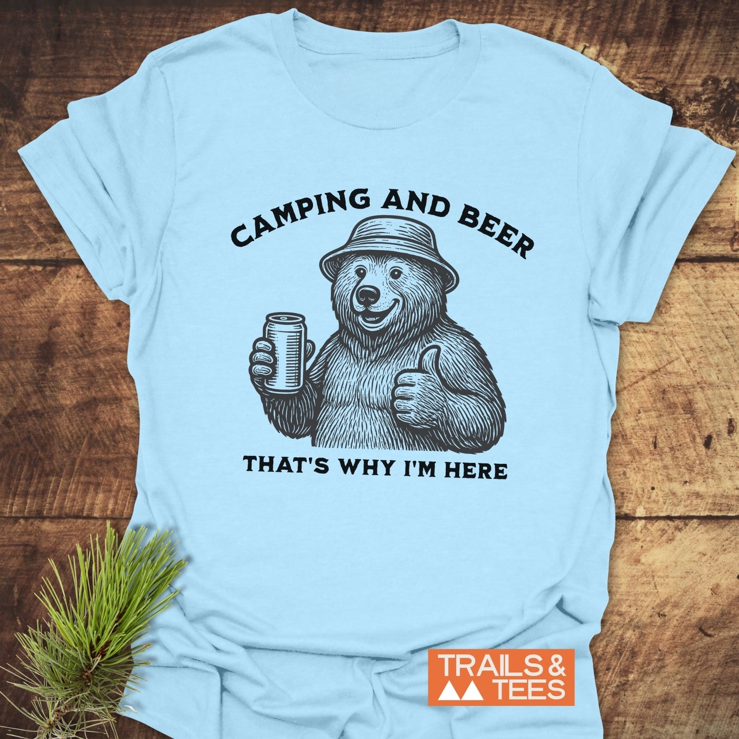 Camping And Beer T-Shirt featuring a bear in a bucket hat, holding a beer, with thumb up. Soft, durable cotton for outdoor enthusiasts.