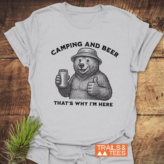 Camping And Beer T-Shirt featuring a smiling bear illustration, crafted from soft cotton for comfort, with durable prints and a Trails & Tees logo.