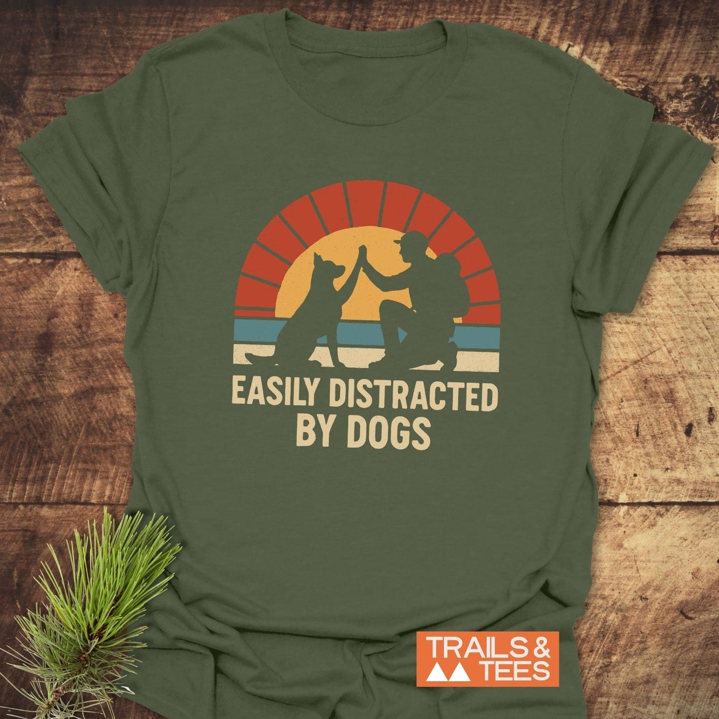 Easily Distracted By Dogs T-Shirt with retro graphic of person high-fiving a dog, crafted from soft cotton for outdoor adventures.