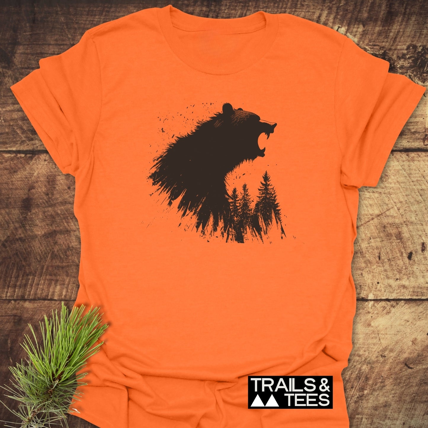 Roaring Bear Forest T-Shirt featuring a roaring bear and tree silhouette graphic on an orange tee, emphasizing outdoor adventure and comfort.