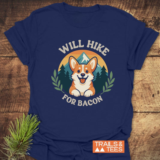 Will Hike For Bacon T-Shirt featuring a cartoon corgi and mountain scene, crafted from soft cotton, ideal for outdoor enthusiasts seeking comfort and style.