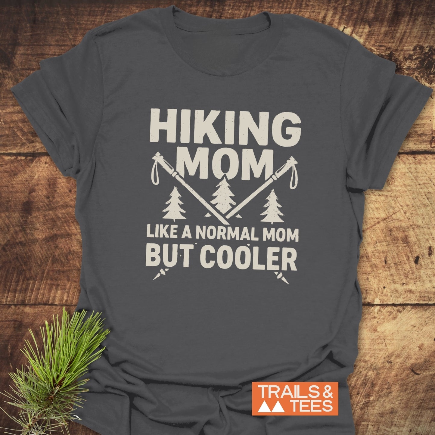 Hiking Mom T-Shirt with crossed poles and pine trees print, crafted from soft cotton for comfort, featuring durable, crack-resistant design.