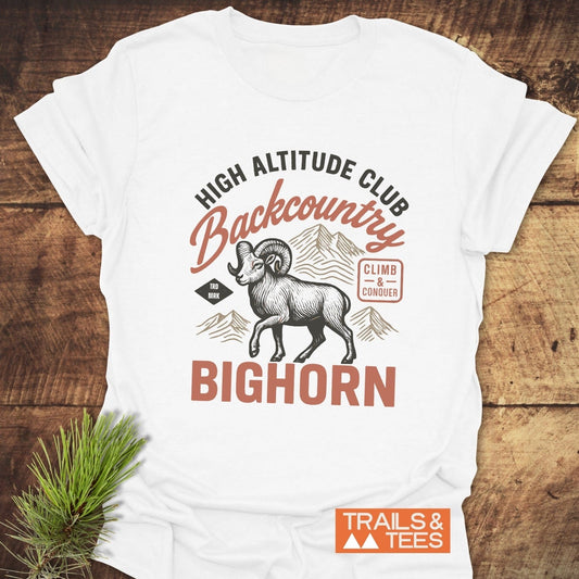 High Altitude Club T-Shirt featuring a bighorn sheep and mountain print, emphasizing outdoor adventure. Made from soft, durable cotton for comfort and reliability.