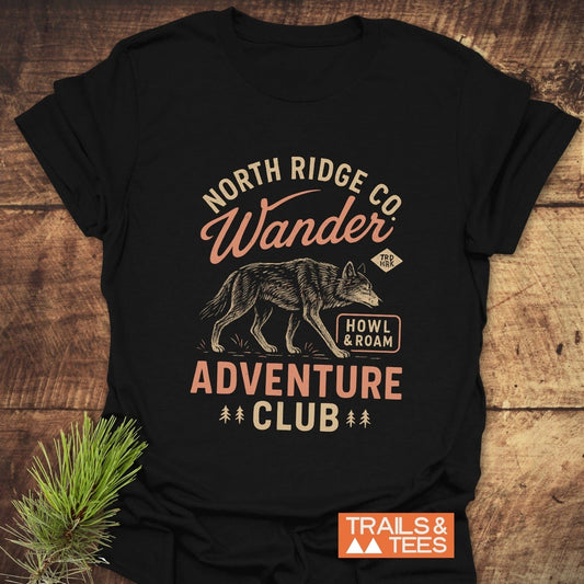 Howl And Roam Wolf T-Shirt with wolf illustration, “North Ridge Co.” and “Adventure Club” text. Features soft cotton, durable print, and taped shoulders.