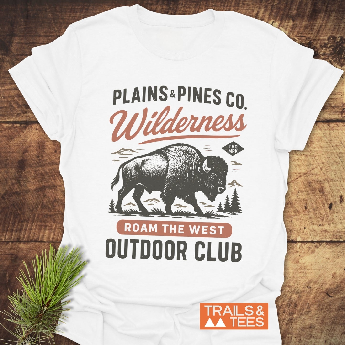 Buffalo Wilderness Club T-Shirt flat-lay featuring bison logo with mountains; text includes ROAM THE WEST and OUTDOOR CLUB; soft, durable cotton for adventure lovers.