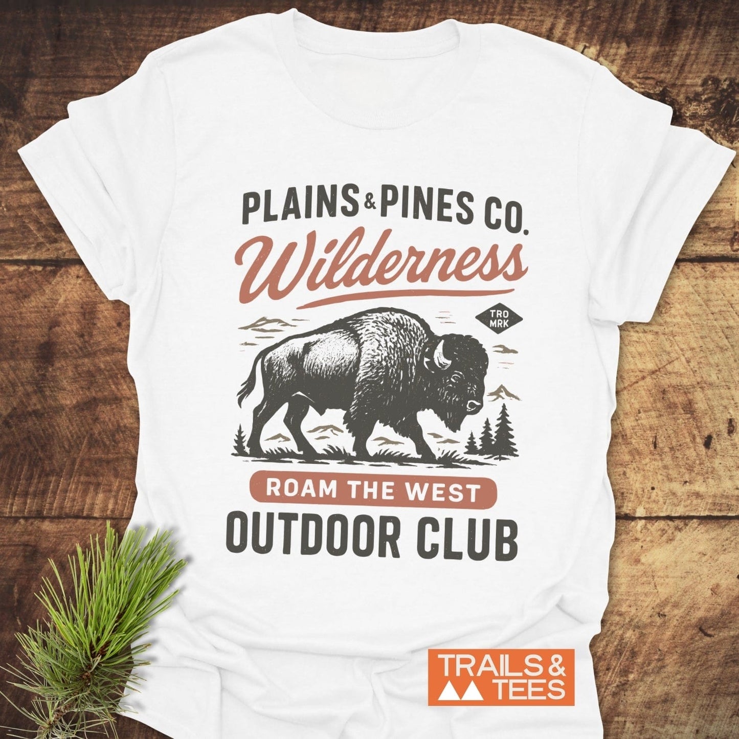 Buffalo Wilderness Club T-Shirt flat-lay featuring bison logo with mountains; text includes ROAM THE WEST and OUTDOOR CLUB; soft, durable cotton for adventure lovers.