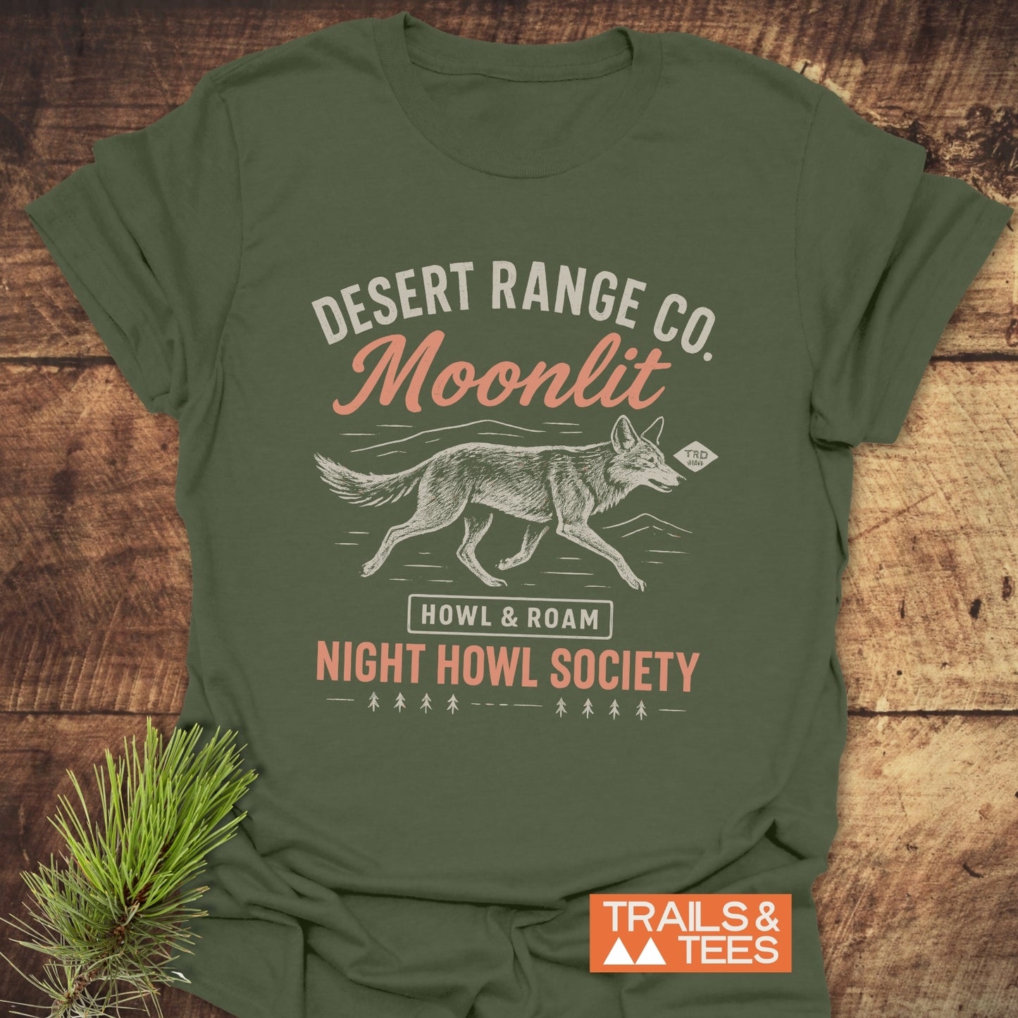 Night Howl Society T-Shirt featuring a running coyote graphic, mountain skyline, and HOWL & ROAM label, designed for outdoor enthusiasts with durable, comfortable fabric.