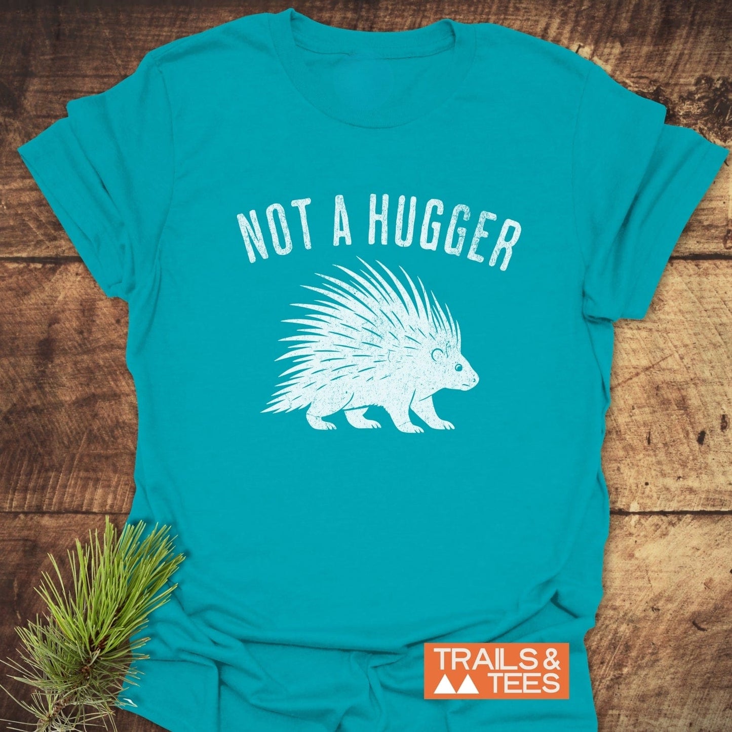 Not A Hugger T-Shirt featuring a porcupine outline and slogan, highlighting durable prints and soft cotton, ideal for outdoor enthusiasts seeking comfort and adventure.
