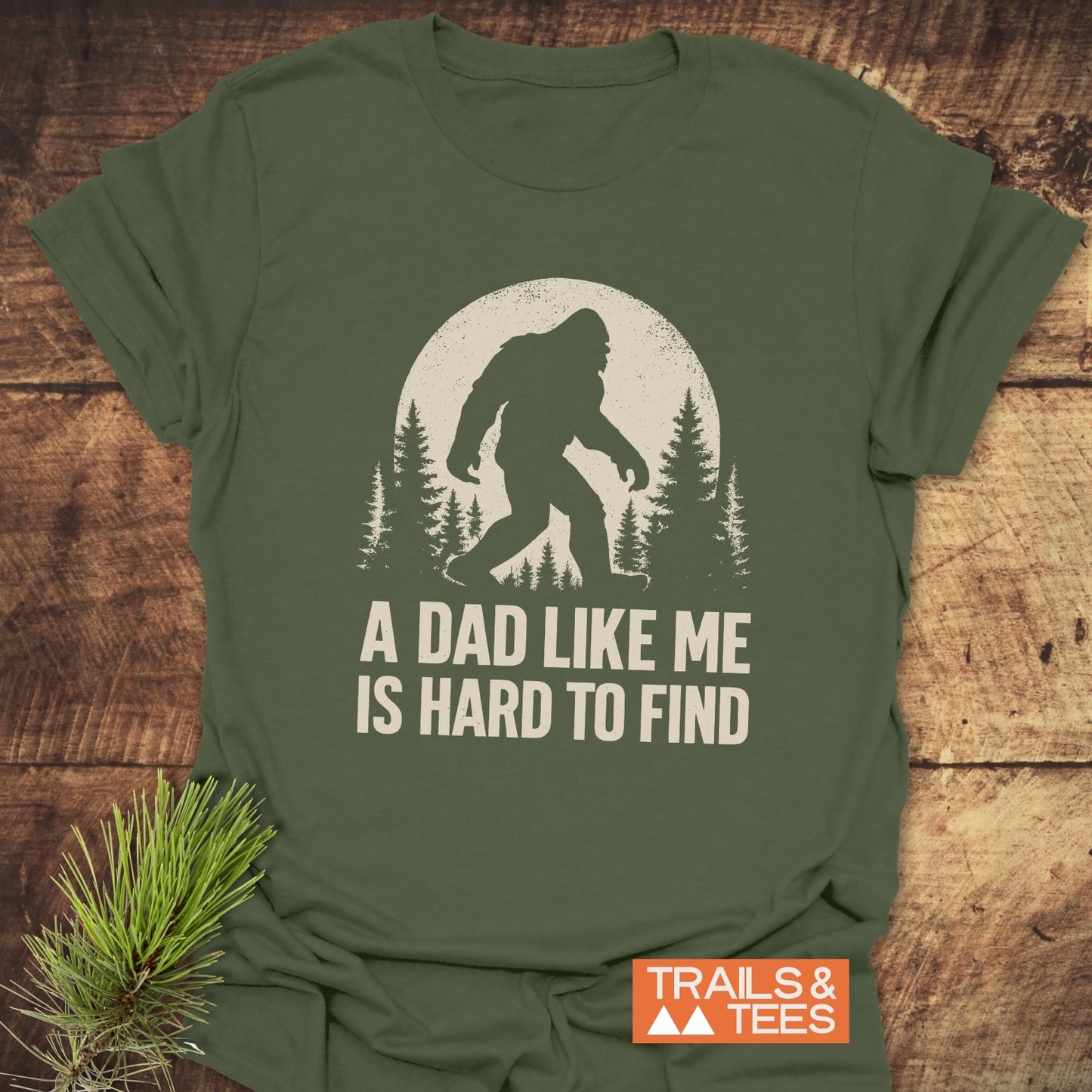 Vintage Bigfoot Dad T-Shirt featuring Sasquatch silhouette with moon and trees. Soft, durable ring-spun cotton, perfect for outdoor enthusiasts. Pre-shrunk, taped shoulders ensure lasting fit.
