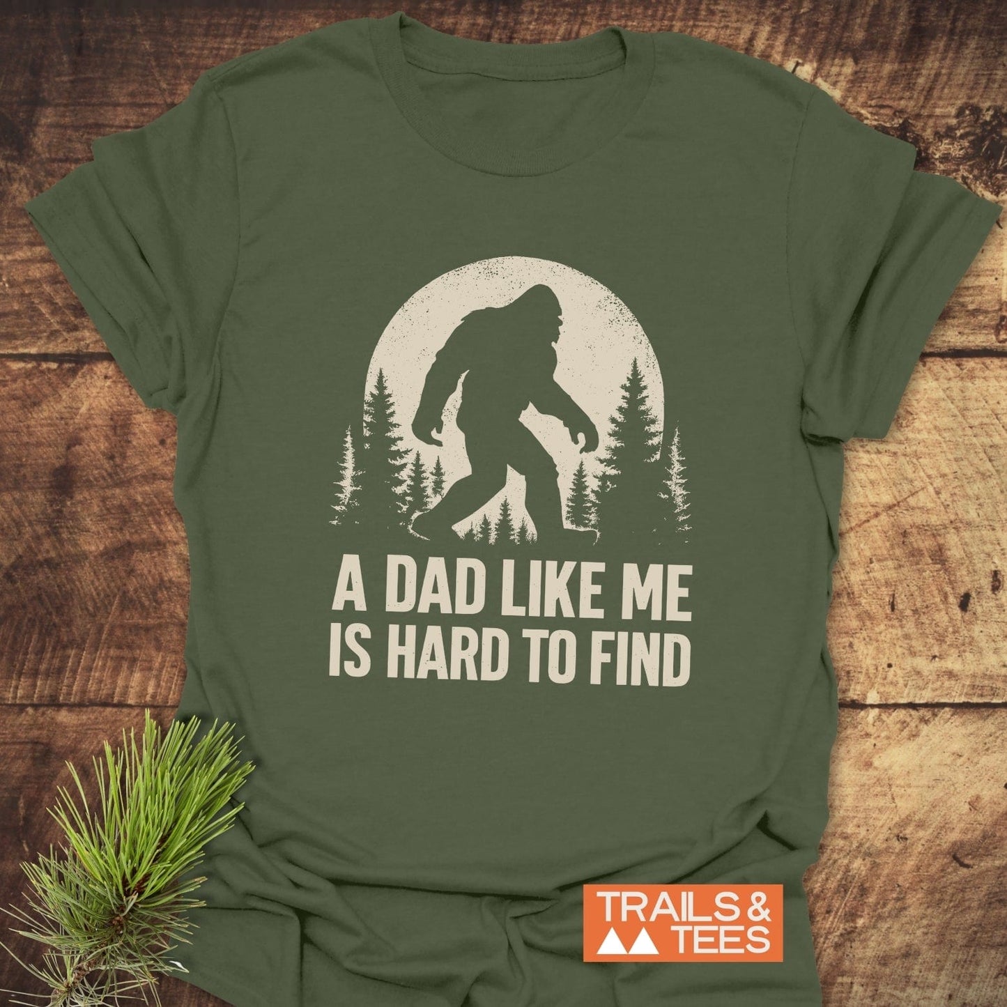 Vintage Bigfoot Dad T-Shirt featuring Sasquatch silhouette with moon and trees. Soft, durable ring-spun cotton, perfect for outdoor enthusiasts. Pre-shrunk, taped shoulders ensure lasting fit.