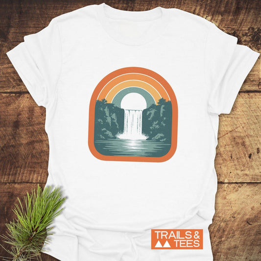 Vintage Waterfall T-Shirt featuring a retro rainbow and waterfall graphic on soft, ring-spun cotton, promising comfort and sustainable style for outdoor enthusiasts.