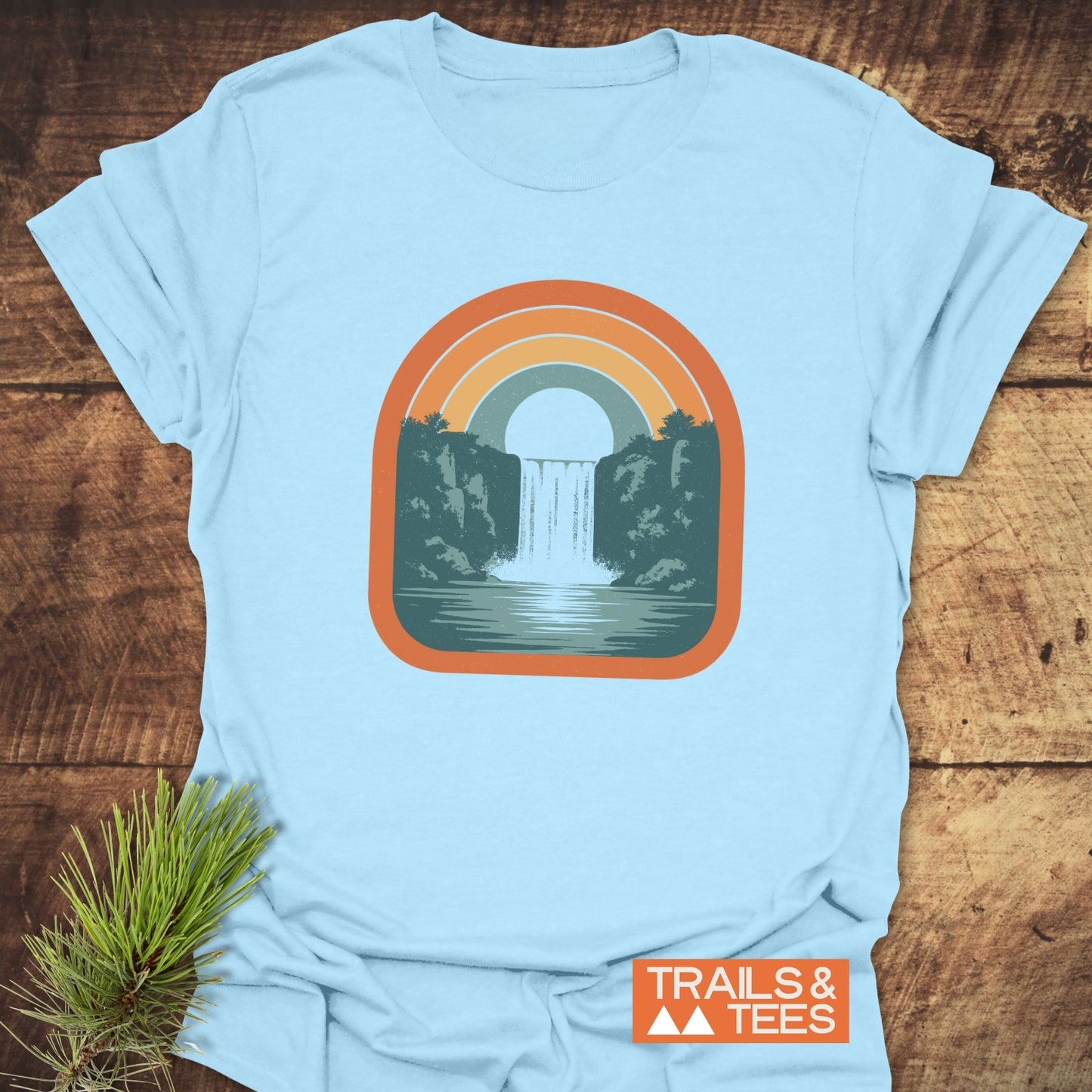 Vintage Waterfall T-Shirt featuring a retro rainbow waterfall graphic on soft, ring-spun cotton, ideal for outdoor lovers seeking comfort and style.