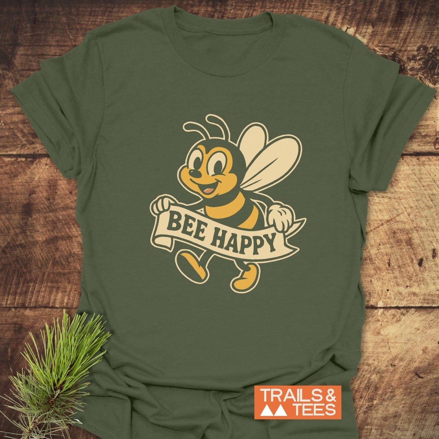 Bee Happy Cheerful T-Shirt showcasing a retro bee with a “BEE HAPPY” banner. Made from ring-spun cotton, designed for comfort and durability.