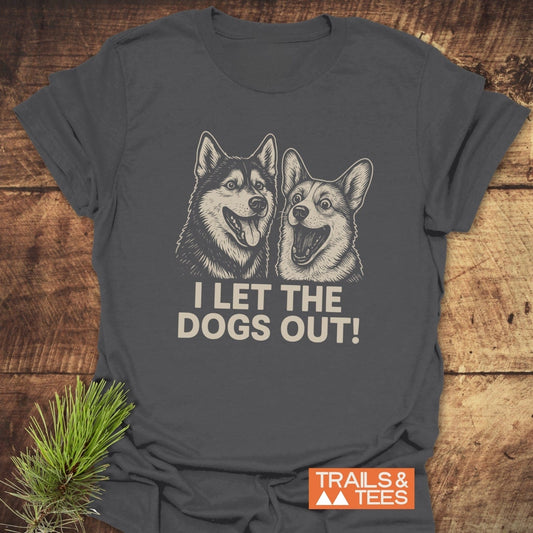 I Let The Dogs Out T-Shirt featuring cartoon Husky and Corgi, slogan, and Trails & Tees logo. Soft, durable, ring-spun cotton, pre-shrunk for a reliable fit.