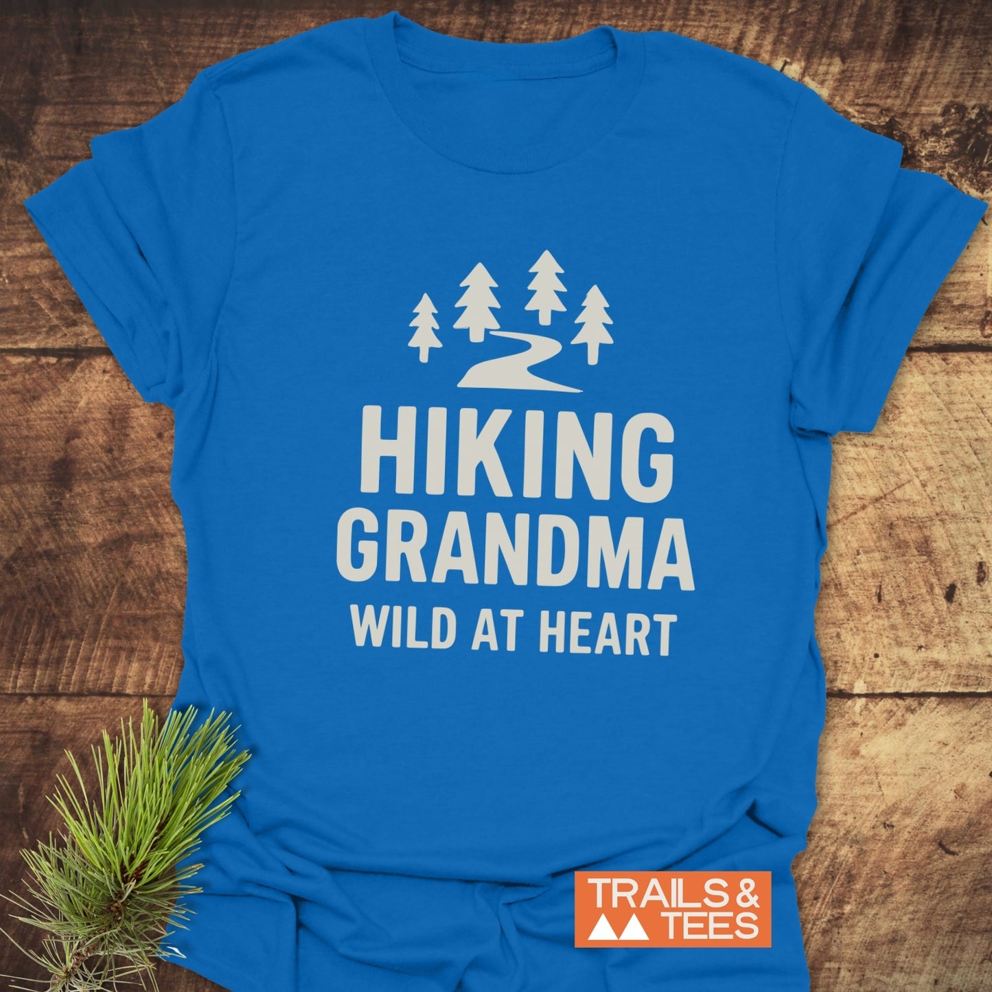 Hiking Grandma - Wild At Heart T-Shirt features a trail and pine graphic, emphasizing comfort and durability for outdoor enthusiasts.