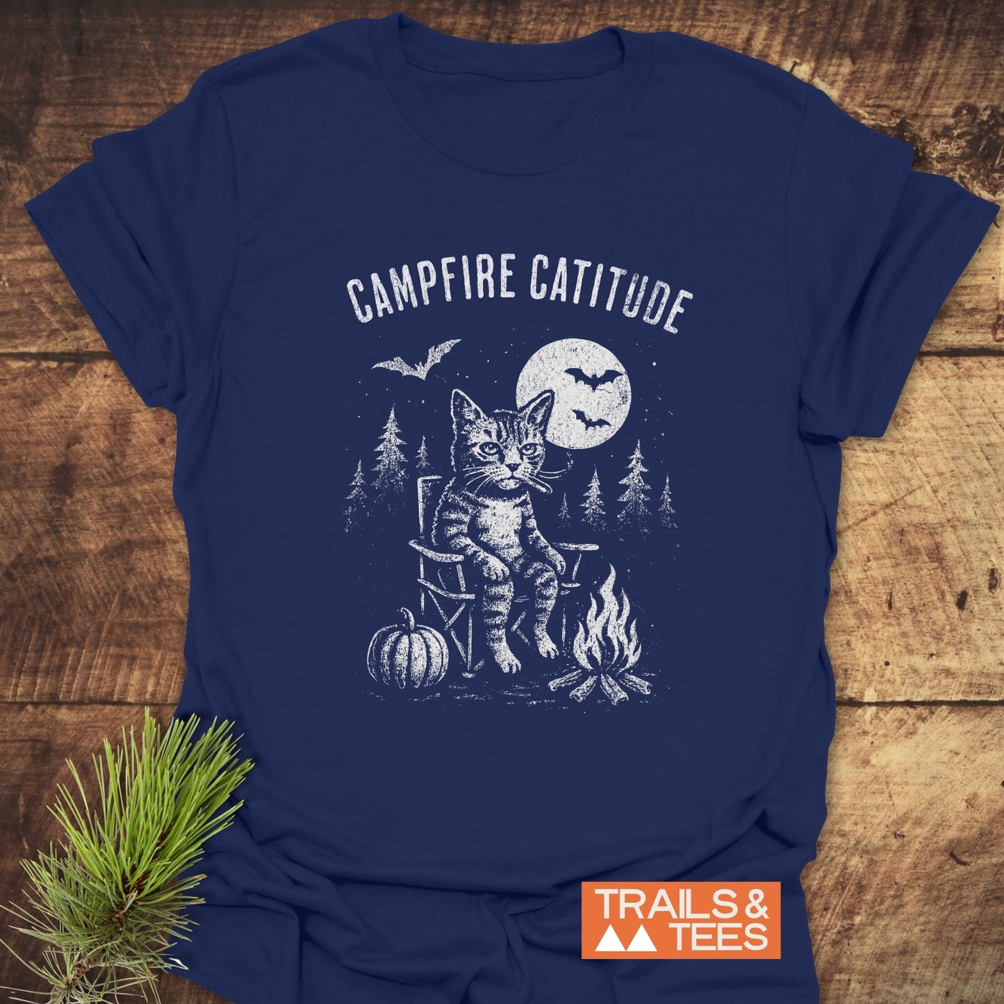Campfire Catitude T-Shirt featuring a grumpy cat by a campfire with bats and moon, crafted from soft cotton for comfort and durability.