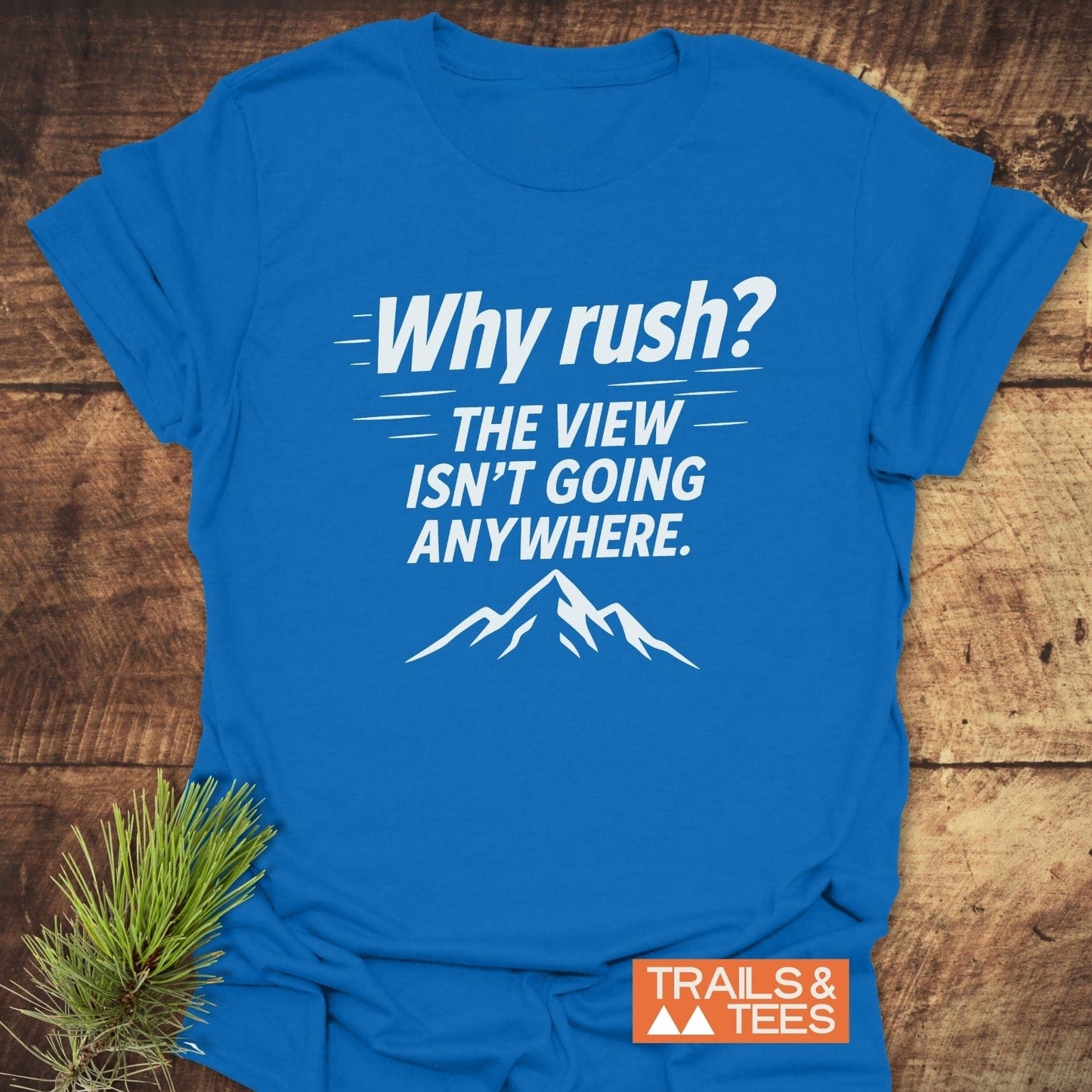 Why Rush? Slow Hikers T-Shirt with mountain range design, featuring soft ring-spun cotton and durable prints, laid flat with a small TRAILS & TEES label visible.