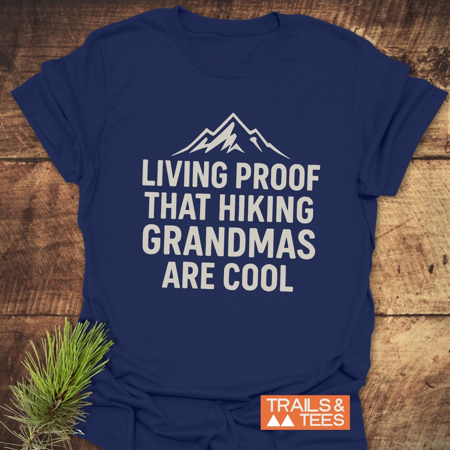 Living Proof Grandma T-Shirt in navy-blue, featuring a white mountain graphic and slogan, showcasing its comfort and durability with a Trails & Tees logo.