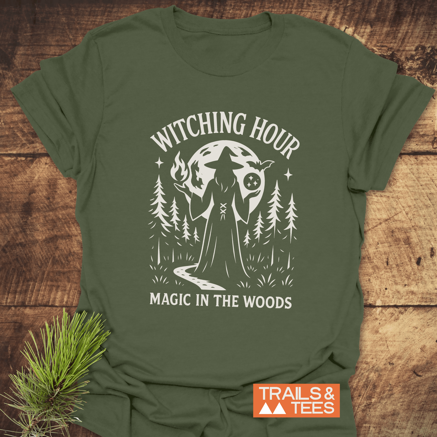 Witching Hour T-Shirt with a graphic of a witch in a forest under a moon, emphasizing outdoor adventure and comfort with durable, pre-shrunk cotton.
