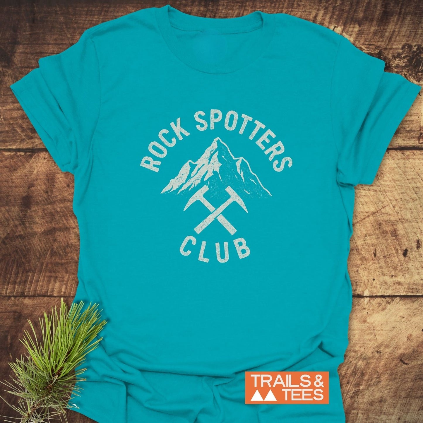 Rock Spotters Club T-Shirt with mountain peak graphic and rock-hammers, featuring durable prints and soft, ring-spun cotton for outdoor enthusiasts.