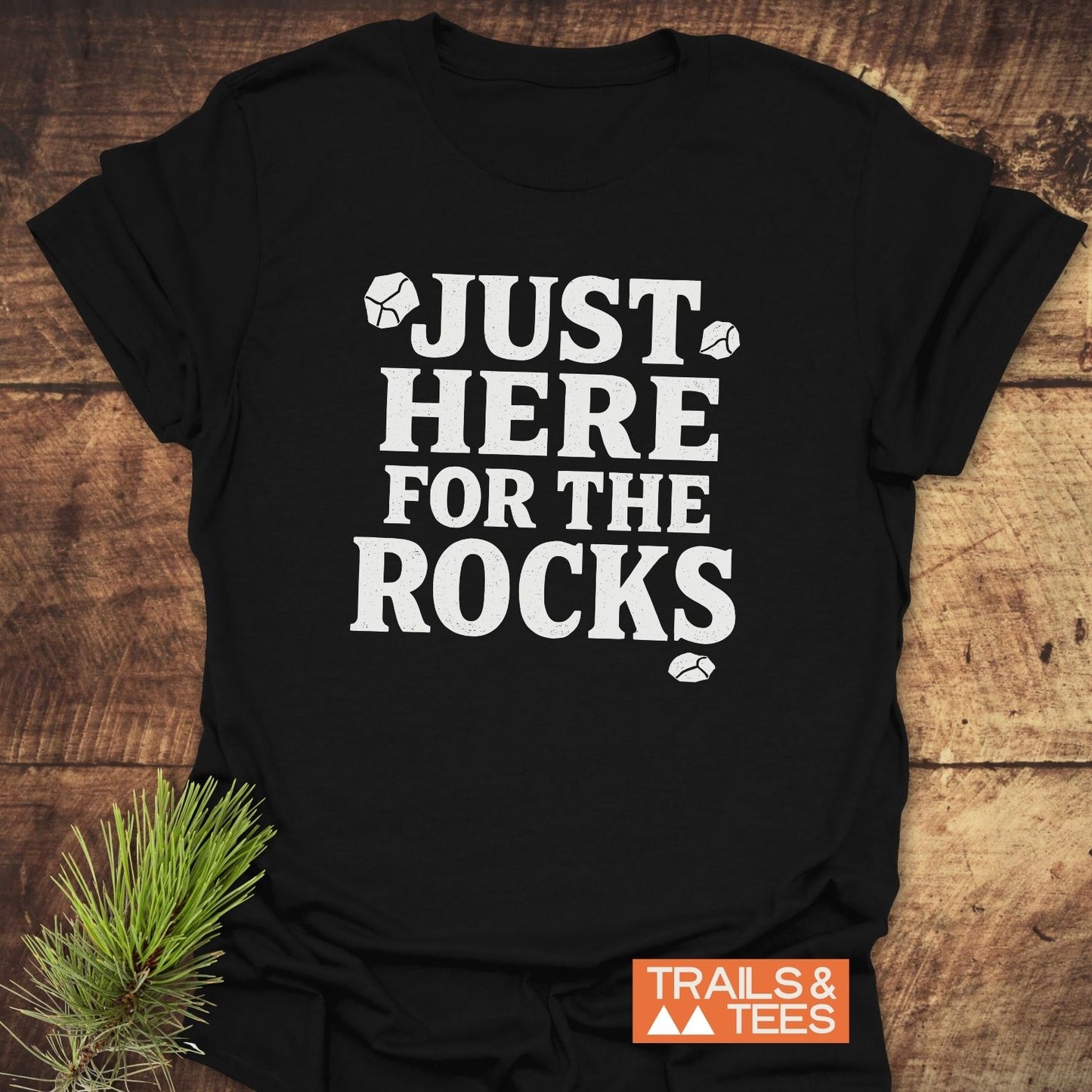 Just Here For The Rocks T-Shirt: Black tee with white slogan and rock illustrations, featuring soft, lightweight ring-spun cotton for comfort and durability.