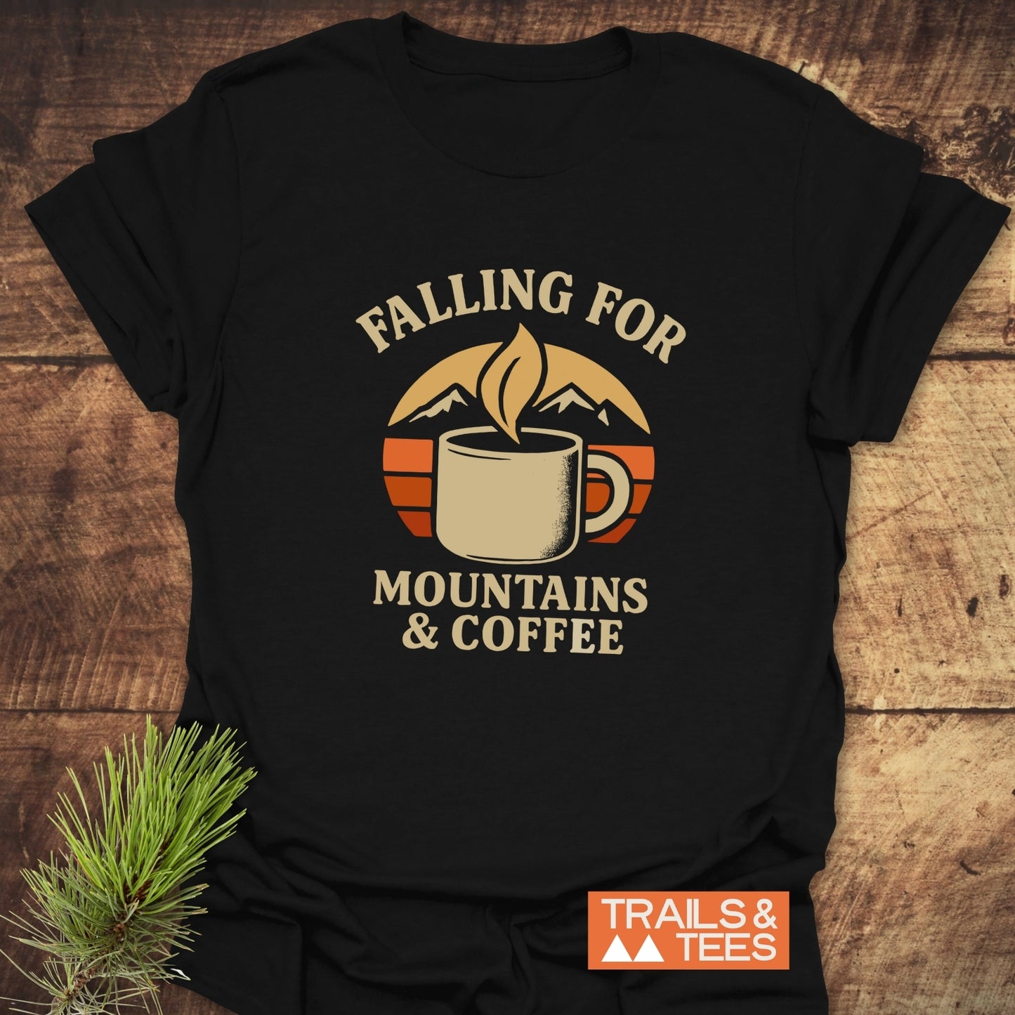 Falling For T-Shirt: Black tee with retro coffee and mountain graphic, slogan, and pine sprig. Soft, ring-spun cotton, durable print.